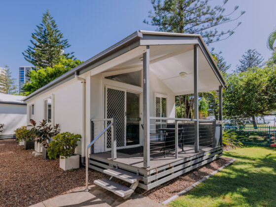 Exterior of a 2 bedroom cabin at Main Beach Tourist Park, featuring a private patio with BBQ.