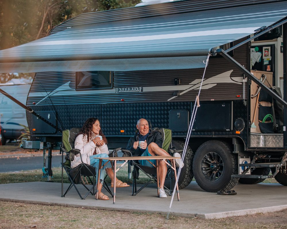 Broadwater-couple sitting in camp chairs with mugs