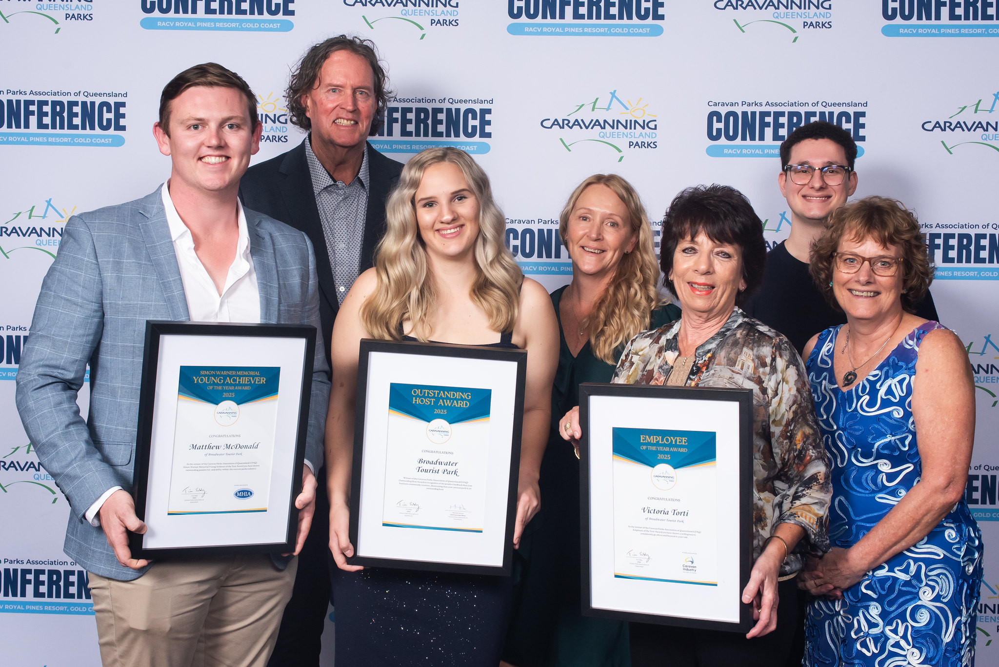 Broadwater Tourist Park staff members at the CPAQ awards night, smiling and holding their award plaque.