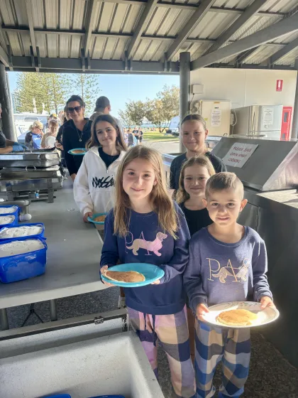 Kids lined up with Pancakes.