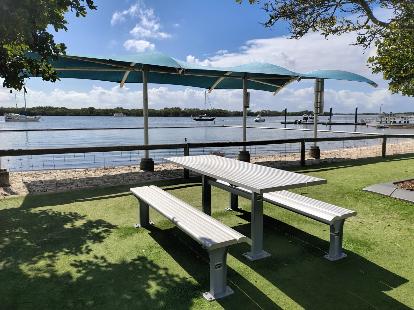 Protected Enclosure: Features an underwater net and floating collar designed to define the swimming zone and deter larger marine life